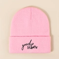 Pink Good Vibes knitted beanie hat with black embroidery on a beige background - Pink