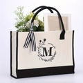 Canvas tote bag with black floral letter M and summer vibe print with black bow detail - Letter-M