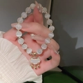 Elegantes weißes Katzenaugen-Perlenarmband mit goldenem Ruyi-Schloss-Anhänger und Zirkonia - Goldener Ruyi-Schloss-Stil (10# Armband-Gold)