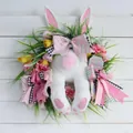 Easter bunny wreath with plush legs, pink tulips, and Happy Easter sign on wood background - 2026 New Bunny Wreath A
