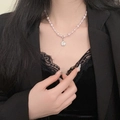 Elegant pearl necklace with crystal pendant on a model wearing black lace and a blazer - Rhinestone Pendant Artificial Pearl Necklace (X4885)
