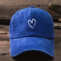 Navy blue washed cotton baseball cap with white heart graphic on dark wood background - One Size (57-59cm) / Sapphire Blue