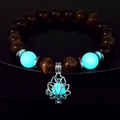 Luminous blue beads and silver lotus charm on a yoga bracelet glowing in the dark - 10mm Coffee Cat's Eye with Blue-Green Light