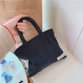 Close-up of dark blue corduroy mini tote bag showing vertical ribbed texture and logo tag - Dark Blue