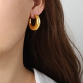Elegant gold-plated stainless steel C-shaped hoop earrings on female model - Gold C-Shaped Earrings