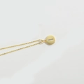 Gold minimalist necklace with a circular letter pendant featuring horizontal crystal pavé - Letter I