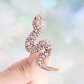 Elegant gold snake brooch featuring sparkling pink and clear rhinestones for women - Pink