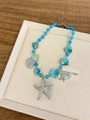 Detailed macro view of ocean-style beads with starfish and seashell alloy pendants - Blue Starfish Style Z-694
