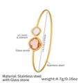 Detail view of gold stainless steel open bangle with orange and purple glass stones - Gold Pink