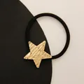 Minimalist elastic hair tie with a textured golden star metal charm in black finish - Pentagram