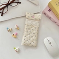 Detail of cream quilted glasses pouch featuring purple floral print and heart button - Beige Purple Flower