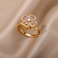 Macro shot of gold floral ring with purple stones on champagne silk fabric background - Gold Purple Clover (G7293829)
