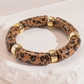 Detail of acrylic leopard print tube bracelet with polished gold metal spacers on stone - Bracelet - Light Coffee