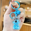 Cute light blue bear backpack keychain with liquid sand, sequins and blue bell - Mini Sitting Bear - Blue