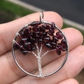 30mm Tree of Life pendant with wire-wrapped deep red garnet stones on a circular metal frame - Garnet Red