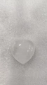 Polished heart-shaped natural white crystal stone pendant on textured background - White Crystal
