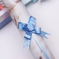 Close-up of blue gift pull bow with elegant rose pattern for festive gift wrapping - Deep Blue Rose