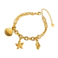 Detail of gold double-layer stainless steel bracelet featuring starfish and seashell charms - Starfish
