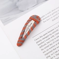 Detail of handmade knit metal hair clip with orange and gray yarn texture on white card - Teardrop / Orange Grey