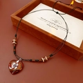 Detail of bohemian heart pendant necklace with wooden beads on a vintage display box - Heart Flower Style / Coffee-Black