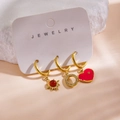 Detail of three 14K gold-plated earrings with red gemstone and heart charms on a card - Red Gem Sun Rhinestone Heart Style (Card P) / 3 Piece Set