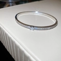 Detailed close-up of a silver-plated bangle featuring a large round zircon center stone - Prong Round Zirconia Style / Silver