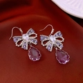 Close-up of bow-knot earrings with purple teardrop crystals on red silk fabric - Purple Bow Earrings / 38# Ear Hook-Silver-Purple