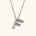 Macro detail of silver 18K plated stainless steel necklace with 3D puffy initial F pendant - Steel-F