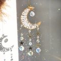 Detail of crescent moon crystal suncatcher with golden wire and rainbow prisms - White Crystal