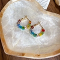 Detail of colorful crystal beaded gold hoop earrings resting on a heart shell tray - 62# Ear Ring - Multicolor