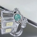 Detail of vintage silver bracelet watch with green dial placed on a luxury perfume bottle - Silver Case Green Dial