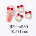 Macro detail of red heart bow nail charm with gold base on a pink manicure - Red (AB89)