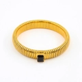 Detail of golden Tubogas snake bracelet featuring a rectangular black zircon gemstone - 12mm Width x 18cm Circumference / Black