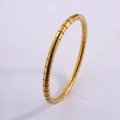 Detailed view of a gold-plated stainless steel bamboo-style flexible bracelet with segment texture - Snake Style / Gold