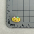 Miniature yellow resin dog charm for nail art and DIY crafts showing 2cm size scale - Yellow Dog with Two Flowers