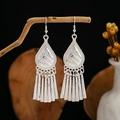 Detailed close-up of ethnic silver leaf tassel earrings hanging on a natural branch - Silver Water Drop Relief Long Tassel Style (E2873-5)