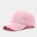 Detailed view of pink baseball cap with cross-texture fabric and six-panel structure - Pink