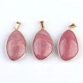 Three oval pink crystal agate pendants with gold plated borders on a white background - Rhodochrosite (Single)