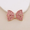 Detail of gold-plated bow charm with pink crystals and shimmering rhinestone center - D1983 Pink Rhinestone Bow