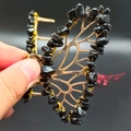 Detail of handcrafted gold butterfly hair clip featuring black natural crystal stones - Obsidian Gold Butterfly