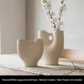 Set of two textured white ceramic vases with hollow circle design on wooden surface - Hammered White Set