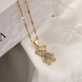 Macro shot of gold plated bear pendant with colorful zircons on a wavy gold chain - Multicolor Zirconia Bear (23660)