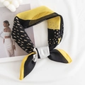 Houndstooth silk scarf with black, yellow, and white geometric patterns in a knotted style - Polka Dot Geometric / Yellow Edge