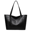 Bolso tote negro minimalista con textura de calaveras y detalle de borlas de cuero - Negro