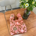 Pink knit tote bag with retro floral patterns on a rustic wooden tabletop - Hydrangea Rose Pink