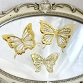 Detail showing three golden hollow-out paper butterflies on a vintage carved mirror - Style 3 / Set of 12 / Gold