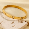 Polished 18k gold plated stainless steel bangle with zircon stones on travertine - Gold Round Zircon