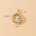 Detailed view of evil eye charm with blue center and rhinestones measuring 2.6cm x 2cm - Gold Round Evil Eye with White Bead Pendant (M)