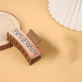 Brown leather hair claw clip featuring a unique chocolate themed decorative pattern - Brown / Chocolate Letters