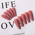Detail view of reddish-brown matte long ballerina press-on nails arranged on white paper - Deep Pink